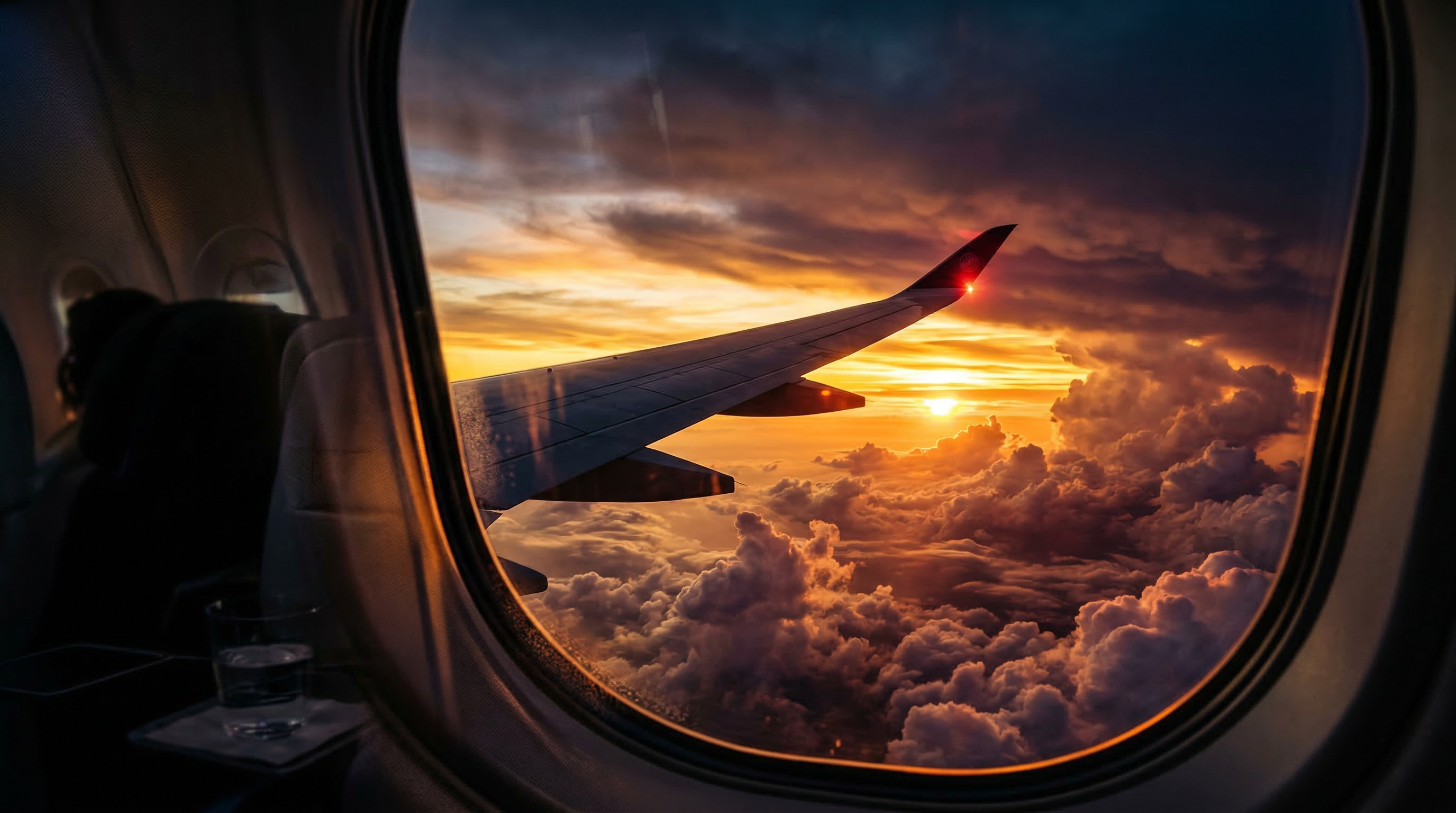 Airplane window view at sunset